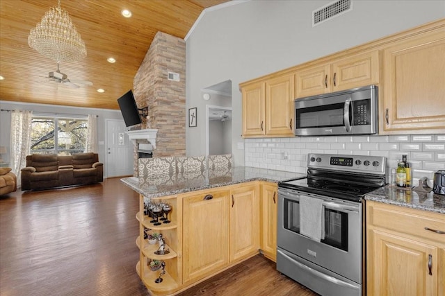 kitchen with hanging light fixtures, dark hardwood / wood-style flooring, kitchen peninsula, ceiling fan with notable chandelier, and appliances with stainless steel finishes