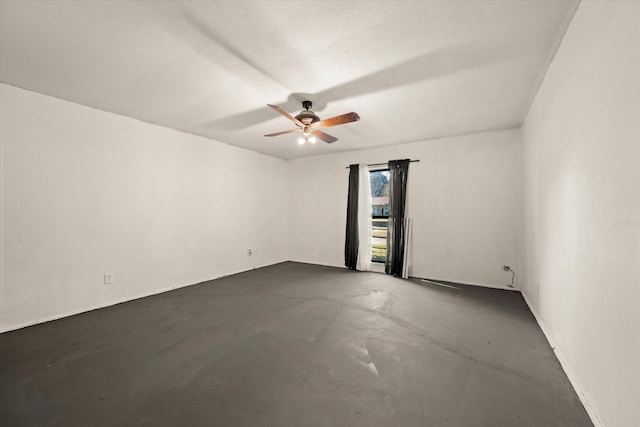 unfurnished room with ceiling fan and a textured ceiling