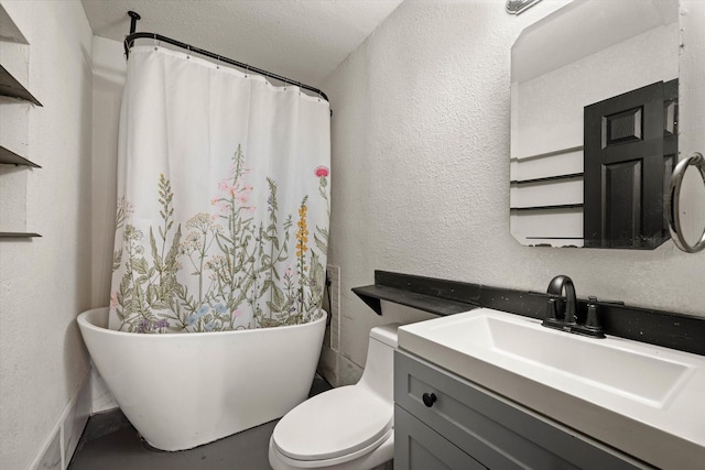 bathroom with vanity, a bath, a textured ceiling, and toilet