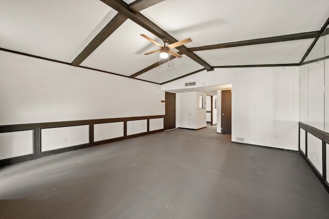 empty room with ceiling fan and lofted ceiling with beams