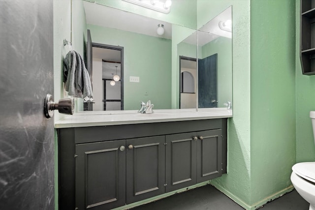 bathroom featuring vanity and toilet