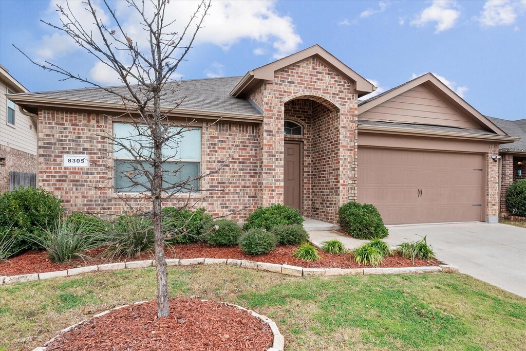 ranch-style home featuring a garage