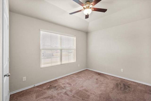 carpeted spare room featuring lofted ceiling and ceiling fan