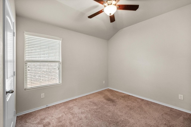 empty room with vaulted ceiling, carpet, and ceiling fan