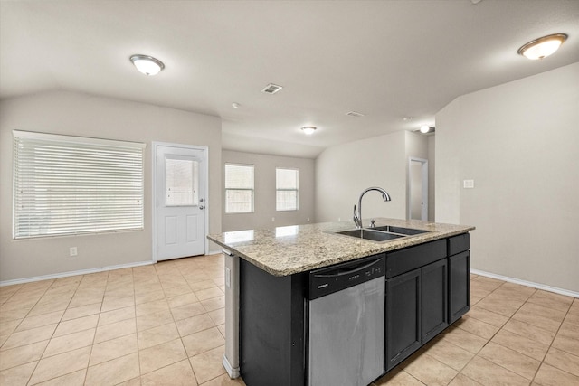 kitchen featuring sink, light stone counters, light tile patterned floors, stainless steel dishwasher, and a kitchen island with sink