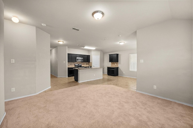 unfurnished living room featuring sink and light colored carpet