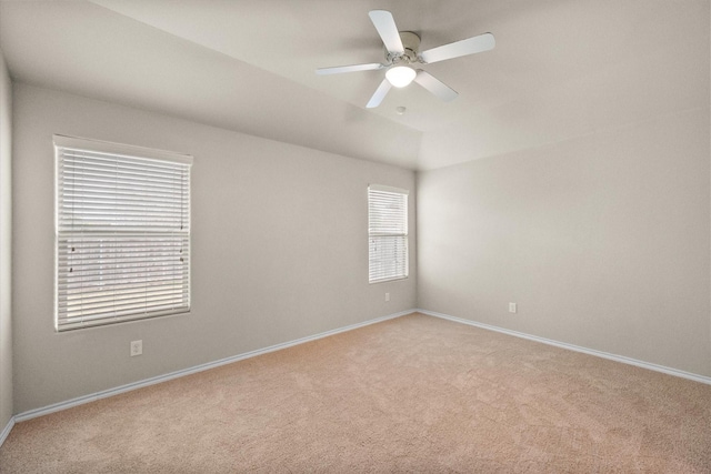 carpeted spare room featuring ceiling fan