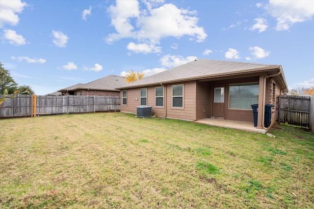 rear view of property featuring a patio, a lawn, and central air condition unit