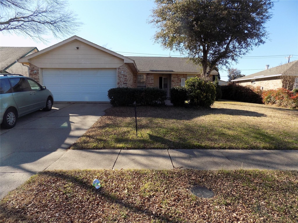 single story home featuring a garage and a front yard