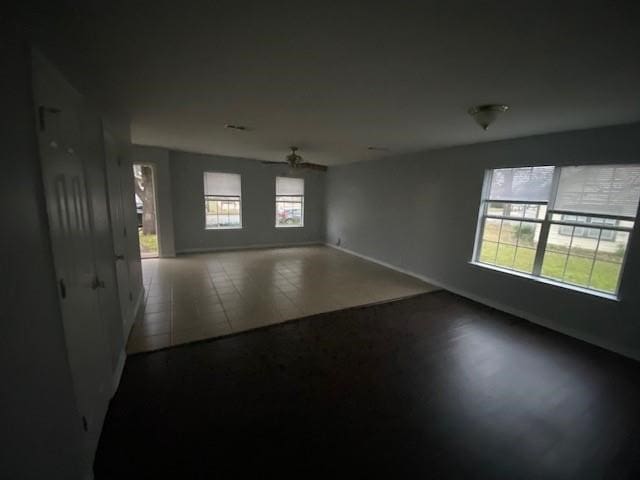 tiled spare room with ceiling fan and a healthy amount of sunlight