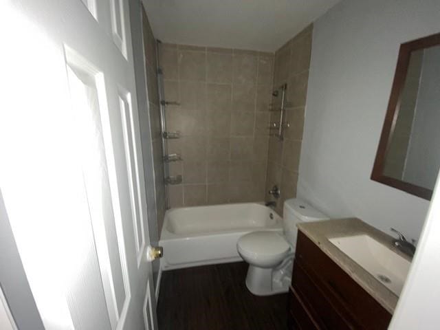 full bathroom with wood-type flooring, vanity, toilet, and tiled shower / bath