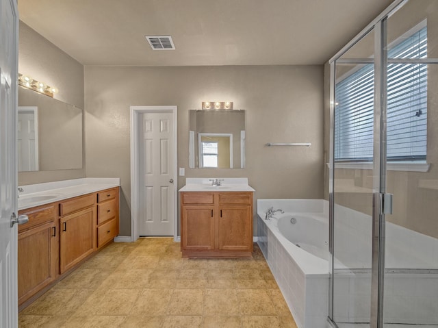 bathroom featuring tile patterned floors, vanity, and shower with separate bathtub