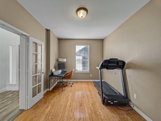 exercise area with light wood-type flooring