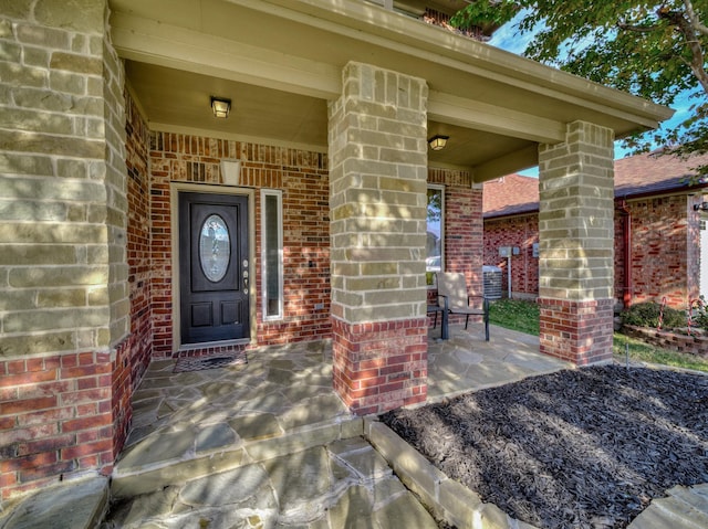 view of exterior entry with covered porch