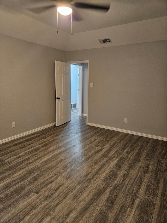 empty room with ceiling fan and dark wood-type flooring