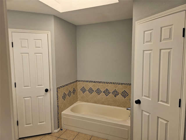 bathroom with tile patterned floors, a bathing tub, and tile walls