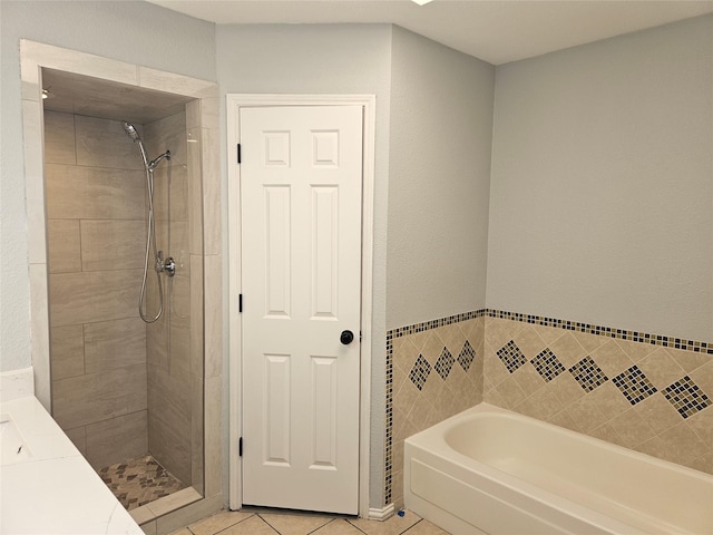 bathroom with separate shower and tub and tile patterned floors