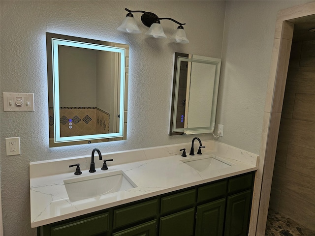 bathroom featuring a tile shower and vanity