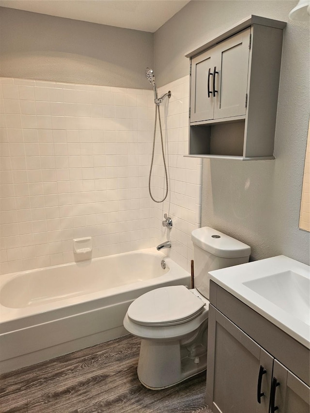 full bathroom featuring shower / bathing tub combination, wood-type flooring, vanity, and toilet