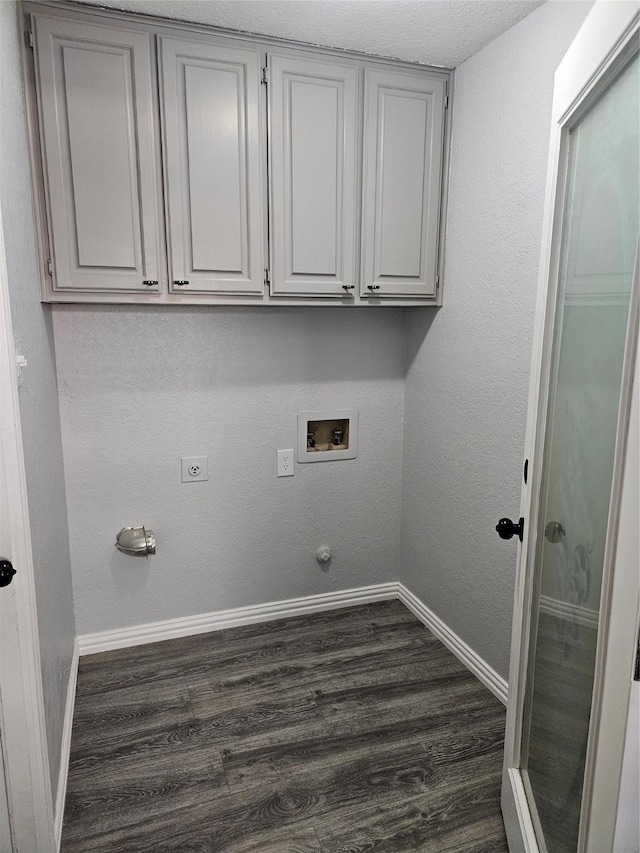 laundry room with dark wood-type flooring, cabinets, hookup for an electric dryer, and hookup for a washing machine