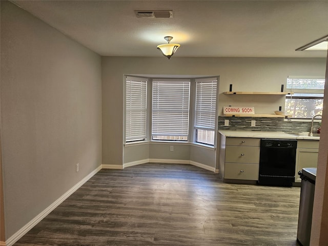 kitchen with sink, backsplash, dark wood-type flooring, and dishwasher