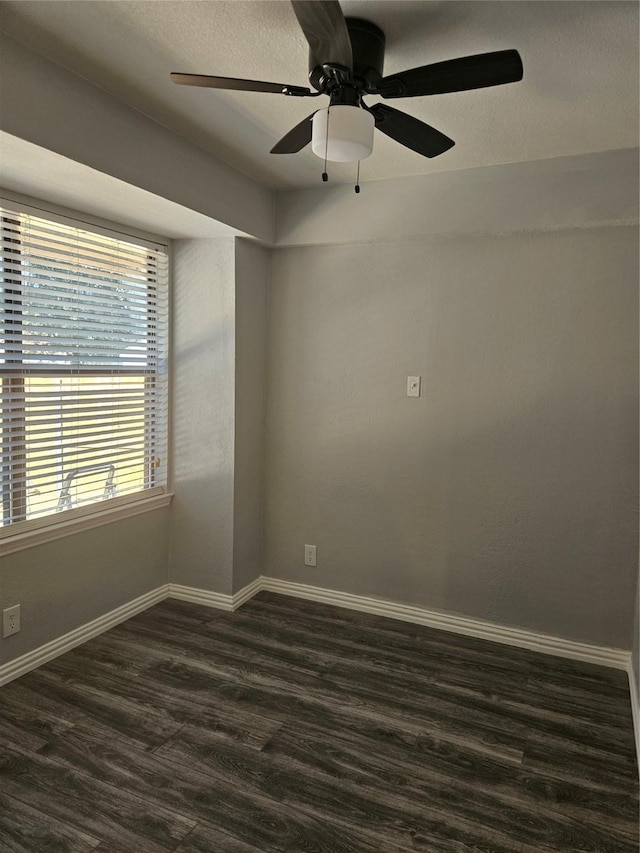 spare room featuring ceiling fan and dark hardwood / wood-style floors