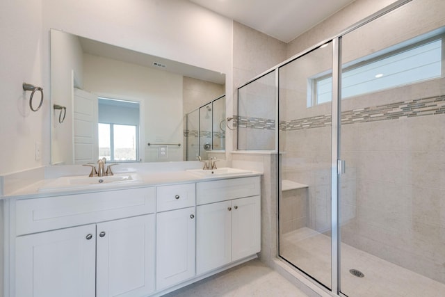 bathroom with vanity and a shower with shower door