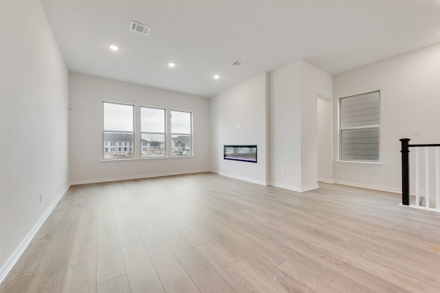 unfurnished living room with light wood-type flooring