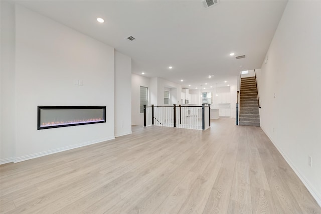 unfurnished living room featuring light wood-type flooring