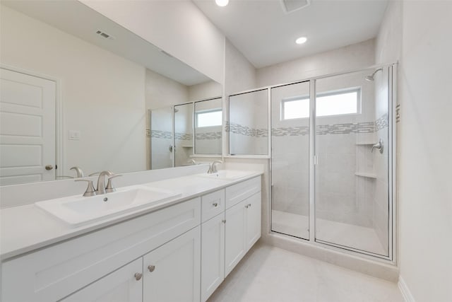 bathroom featuring vanity, an enclosed shower, and tile patterned floors