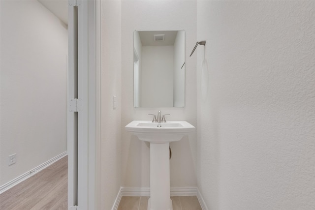 bathroom featuring wood-type flooring and sink