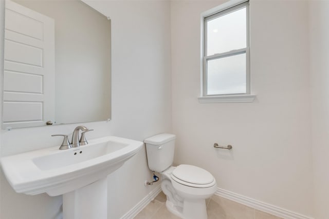 bathroom with tile patterned flooring, sink, and toilet