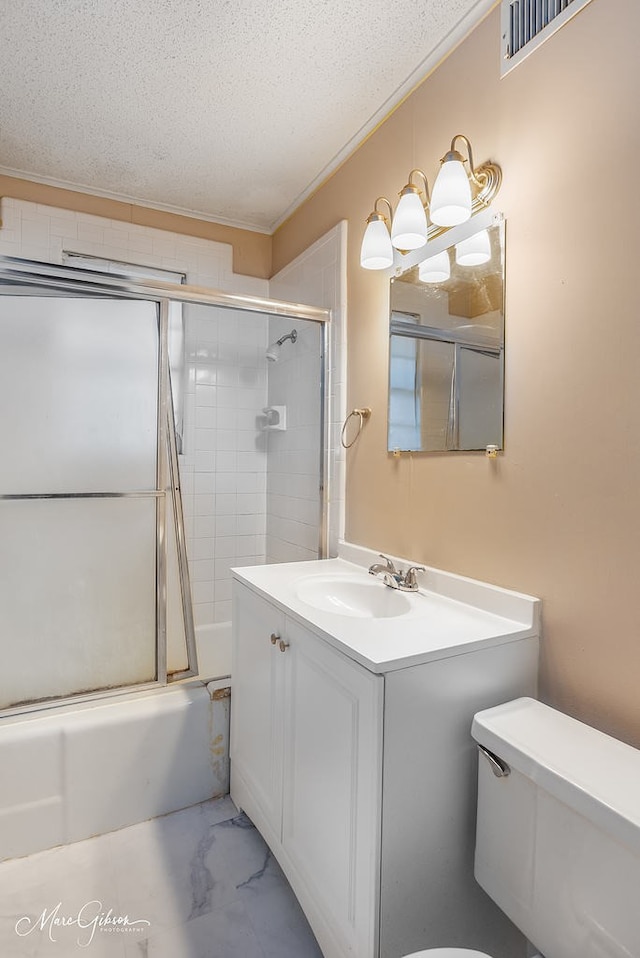 full bathroom with vanity, enclosed tub / shower combo, a textured ceiling, and toilet