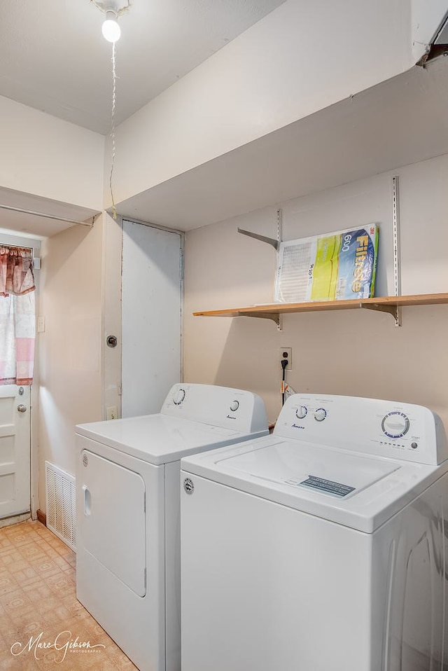 clothes washing area with washer and dryer