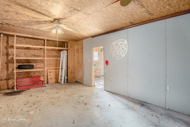 spare room featuring ceiling fan and concrete flooring