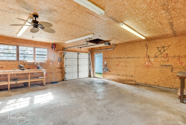 garage featuring a workshop area, ceiling fan, and a garage door opener