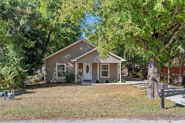 view of front of home with a front yard and covered porch