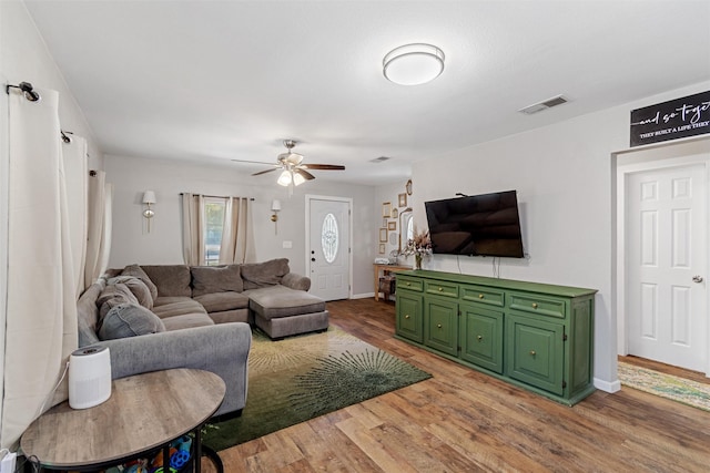 living room featuring hardwood / wood-style flooring and ceiling fan