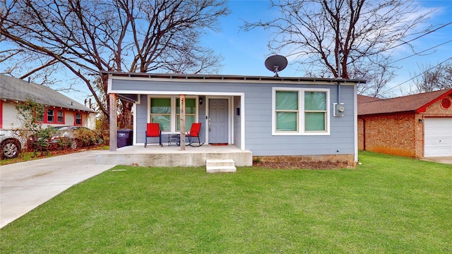 view of front facade with a garage, a front yard, and covered porch