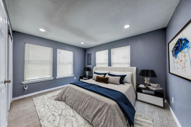 carpeted bedroom with electric panel and a textured ceiling