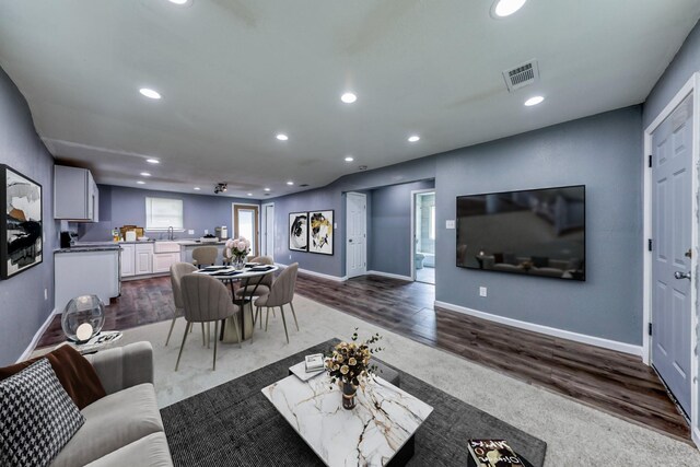 living room featuring dark hardwood / wood-style floors and ceiling fan