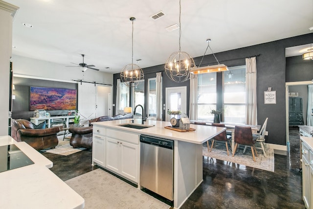 kitchen featuring stainless steel dishwasher, ceiling fan, sink, a barn door, and hanging light fixtures