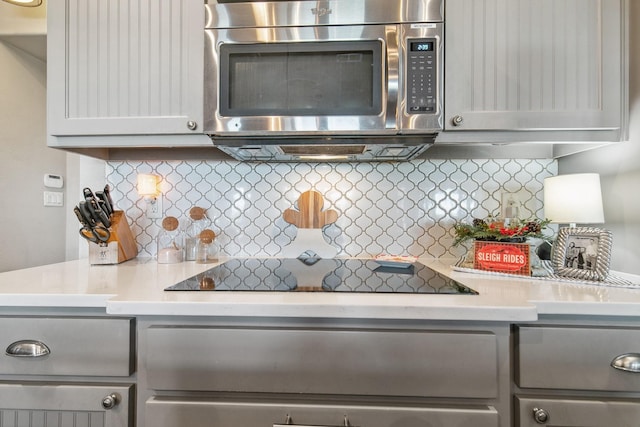 kitchen with tasteful backsplash and black electric stovetop