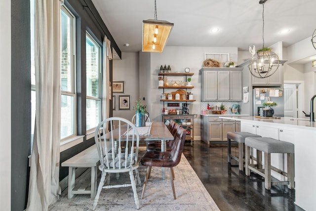 dining area with a chandelier and sink