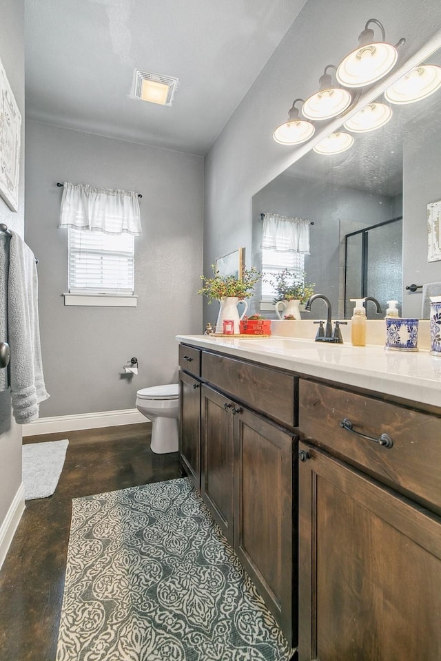 bathroom featuring hardwood / wood-style floors, vanity, an enclosed shower, and toilet