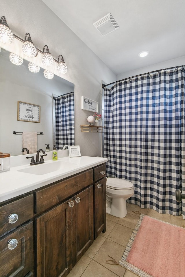 bathroom featuring tile patterned flooring, vanity, and toilet