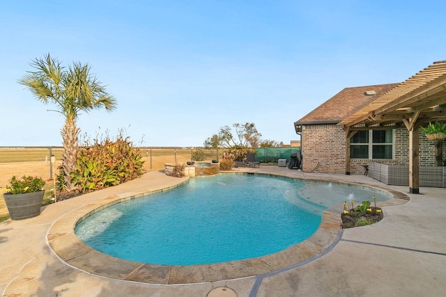 view of pool with a patio area and an in ground hot tub