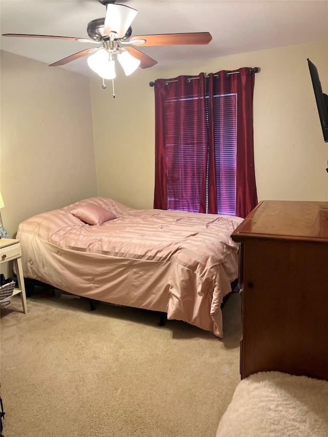 bedroom with ceiling fan and carpet floors