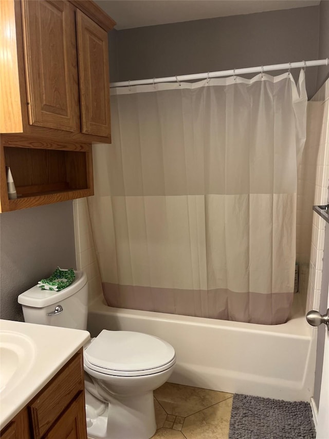 bathroom featuring tile patterned flooring, vanity, and toilet