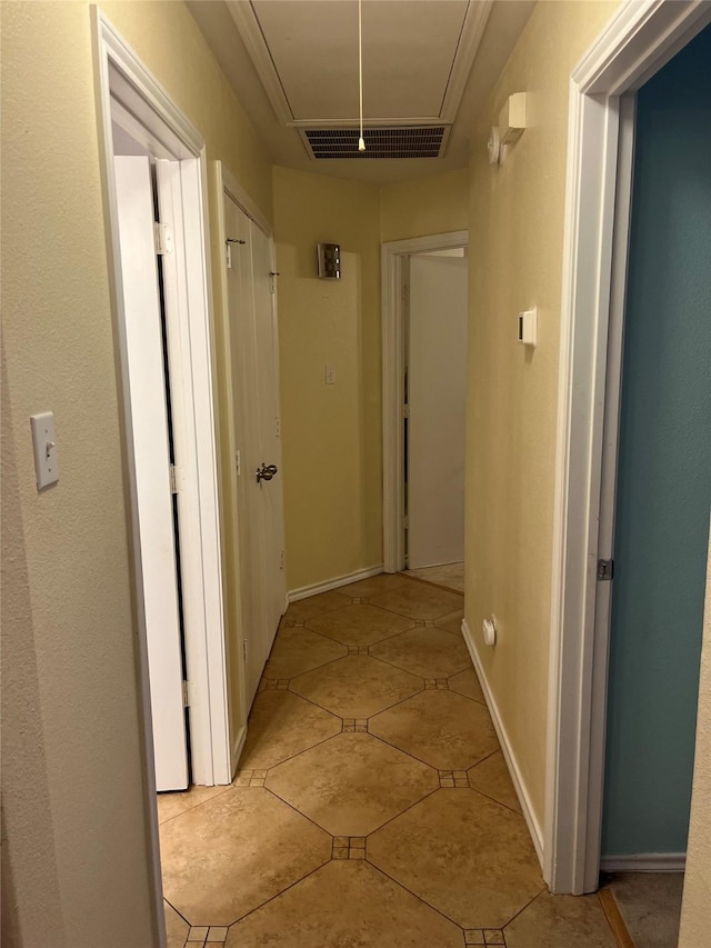 corridor featuring light tile patterned floors